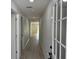 Bright hallway with modern flooring and neutral walls leads to other rooms at 31 Juniper Pass Ln, Ocala, FL 34480