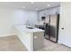 Well-lit kitchen with stainless steel appliances and quartz countertop island with seating at 31 Juniper Pass Ln, Ocala, FL 34480