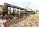 Home's backyard features mulched landscape and glass enclosed patio at 3447 Sw 19Th Pl, Ocala, FL 34474
