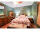 Cozy bedroom with wood floors, a ceiling fan, and unique decor at 3447 Sw 19Th Pl, Ocala, FL 34474