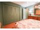 Bedroom featuring wood floors, closet, dresser, and a mirror at 3447 Sw 19Th Pl, Ocala, FL 34474