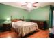 Cozy bedroom with ceiling fan, wood floors and decor at 3447 Sw 19Th Pl, Ocala, FL 34474