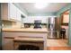 Bright kitchen featuring white cabinets, stainless steel appliances, and a breakfast bar at 3447 Sw 19Th Pl, Ocala, FL 34474