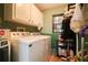 The laundry room includes a washer, dryer, storage shelves and cabinets at 3447 Sw 19Th Pl, Ocala, FL 34474