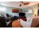 Comfortable living room with hardwood floors, a ceiling fan, and ample natural light at 3447 Sw 19Th Pl, Ocala, FL 34474