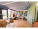 Sunroom with tile flooring, many windows, and a view to the home's yard at 3447 Sw 19Th Pl, Ocala, FL 34474