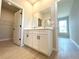 Bathroom vanity with double sinks, large mirror, and access to a walk-in closet at 4059 Sw 131St Place Rd, Ocala, FL 34473