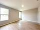 Bright bedroom with wood-look tile flooring and two windows providing natural light at 4059 Sw 131St Place Rd, Ocala, FL 34473