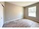 Bright bedroom with wood-look tile floors and a large window at 4059 Sw 131St Place Rd, Ocala, FL 34473
