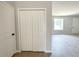 Hallway featuring wood-look tile flooring, closet with folding doors, and access to other rooms at 4059 Sw 131St Place Rd, Ocala, FL 34473