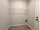 Laundry room featuring tile flooring, washer/dryer hookups, and a wire shelf at 4059 Sw 131St Place Rd, Ocala, FL 34473