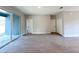 Living space features tile flooring, neutral walls, sliding glass doors, and easy access to other rooms at 4059 Sw 131St Place Rd, Ocala, FL 34473