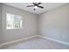 Neutral bedroom featuring a ceiling fan and window with natural light at 4869 Nw 101St Street Rd, Ocala, FL 34482