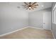 Neutral bedroom featuring modern ceiling fan and tile flooring at 4869 Nw 101St Street Rd, Ocala, FL 34482