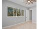 Bedroom featuring a large window overlooking a scenic wooded landscape at 4869 Nw 101St Street Rd, Ocala, FL 34482