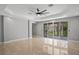 Spacious bedroom with recessed lighting, tile floors, and sliding glass doors to outdoor porch at 4869 Nw 101St Street Rd, Ocala, FL 34482