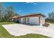 This home features an attached 3 car garage and concrete driveway at 4869 Nw 101St Street Rd, Ocala, FL 34482