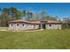 Beautiful single-story home features a well-manicured lawn and inviting front entrance at 4869 Nw 101St Street Rd, Ocala, FL 34482