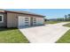 Attached three-car garage with modern doors and ample parking space at 4869 Nw 101St Street Rd, Ocala, FL 34482