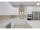 Bright kitchen features a center island, stainless steel appliances and stone backsplash at 4869 Nw 101St Street Rd, Ocala, FL 34482