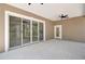 Covered patio with ceiling fans and large sliding glass doors at 4869 Nw 101St Street Rd, Ocala, FL 34482