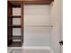 Modern walk-in closet with wood shelving and rod, perfect for organized storage at 4869 Nw 101St Street Rd, Ocala, FL 34482