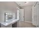 Walk-in closet featuring a vanity and ample storage with modular white shelving units at 4869 Nw 101St Street Rd, Ocala, FL 34482