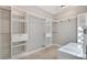 Bright walk-in closet with white modular shelving and drawers next to vanity at 4869 Nw 101St Street Rd, Ocala, FL 34482