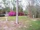 Spacious backyard featuring lush greenery, vibrant azaleas, and a decorative birdbath, creating a serene outdoor retreat at 5181 Sw 164Th Street Rd, Ocala, FL 34473