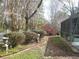 Landscaped backyard featuring a mix of garden art, greenery, and a walkway at 5181 Sw 164Th Street Rd, Ocala, FL 34473