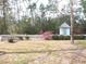 Charming backyard with a white picket fence, colorful azaleas, and a cute shed, offering a picturesque outdoor retreat at 5181 Sw 164Th Street Rd, Ocala, FL 34473