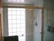 Bright bathroom features a glass-enclosed shower, chrome fixtures, and a modern towel rack at 5181 Sw 164Th Street Rd, Ocala, FL 34473