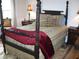 Bedroom with a four-poster bed, patterned bedding, and side tables, offering a sophisticated and comfortable retreat at 5181 Sw 164Th Street Rd, Ocala, FL 34473