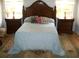 Bedroom with a large wood headboard, matching nightstands, and a decorative rug creating a cozy and inviting atmosphere at 5181 Sw 164Th Street Rd, Ocala, FL 34473