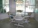 Bright breakfast nook with a glass top table and views of the outdoor pool area at 5181 Sw 164Th Street Rd, Ocala, FL 34473