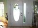 Bright entryway featuring a decorative front door and sidelight, offering a glimpse into the home's interior at 5181 Sw 164Th Street Rd, Ocala, FL 34473