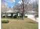 Charming single-story home with a well-manicured lawn and mature trees creating a welcoming curb appeal at 5181 Sw 164Th Street Rd, Ocala, FL 34473
