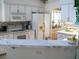 Bright kitchen features white cabinetry, breakfast bar, and modern appliances at 5181 Sw 164Th Street Rd, Ocala, FL 34473