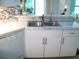 Close-up of kitchen sink with white cabinets and stainless-steel faucet at 5181 Sw 164Th Street Rd, Ocala, FL 34473