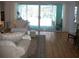 Comfortable living room with hardwood floors, plush seating, and sliding glass doors leading to the lanai at 5181 Sw 164Th Street Rd, Ocala, FL 34473