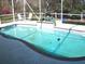 The backyard pool features a fountain and a cozy seating area under a screened enclosure at 5181 Sw 164Th Street Rd, Ocala, FL 34473