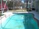 Enclosed pool offering a refreshing escape with a brick-lined edge in a private backyard oasis at 5181 Sw 164Th Street Rd, Ocala, FL 34473