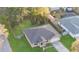 Aerial view of a single-story home surrounded by lush landscaping and mature trees at 5758 Nw 63Rd Pl, Ocala, FL 34482
