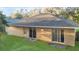 Expansive backyard with lush green grass and a beige exterior, creating a private outdoor oasis at 5758 Nw 63Rd Pl, Ocala, FL 34482