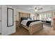 Spacious bedroom with a large bed, a ceiling fan, and natural light from a large window at 5758 Nw 63Rd Pl, Ocala, FL 34482