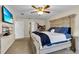 Bright bedroom featuring a large bed, ceiling fan, and closet space in a neutral color palette at 5758 Nw 63Rd Pl, Ocala, FL 34482