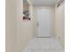Inviting entryway featuring elegant white marble floors and a classic white front door at 5758 Nw 63Rd Pl, Ocala, FL 34482