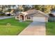 Charming one-story home with a well-manicured lawn and an attached two-car garage at 5758 Nw 63Rd Pl, Ocala, FL 34482