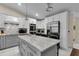 Modern kitchen with stainless steel appliances, white cabinets, and granite countertops at 5758 Nw 63Rd Pl, Ocala, FL 34482