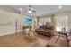 Cozy living room featuring hardwood floors and comfortable leather sofas with natural lighting at 5758 Nw 63Rd Pl, Ocala, FL 34482